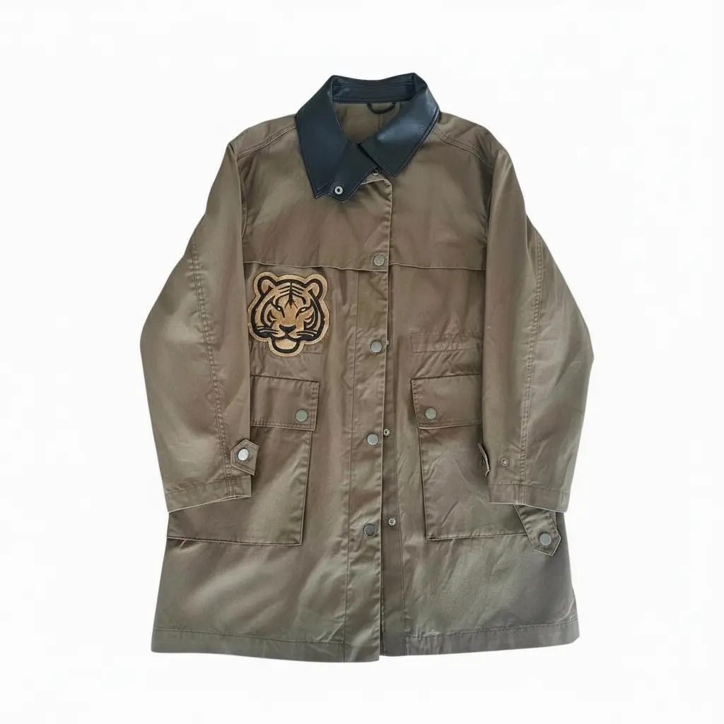 Khaki safari trench coat with black faux-leather collar and faux-leather tiger appliqu&eacute; on the chest