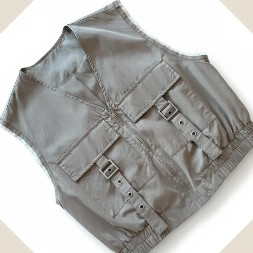 Stone-coloured utility safari vest with multiple pockets and silver tiger print on the back