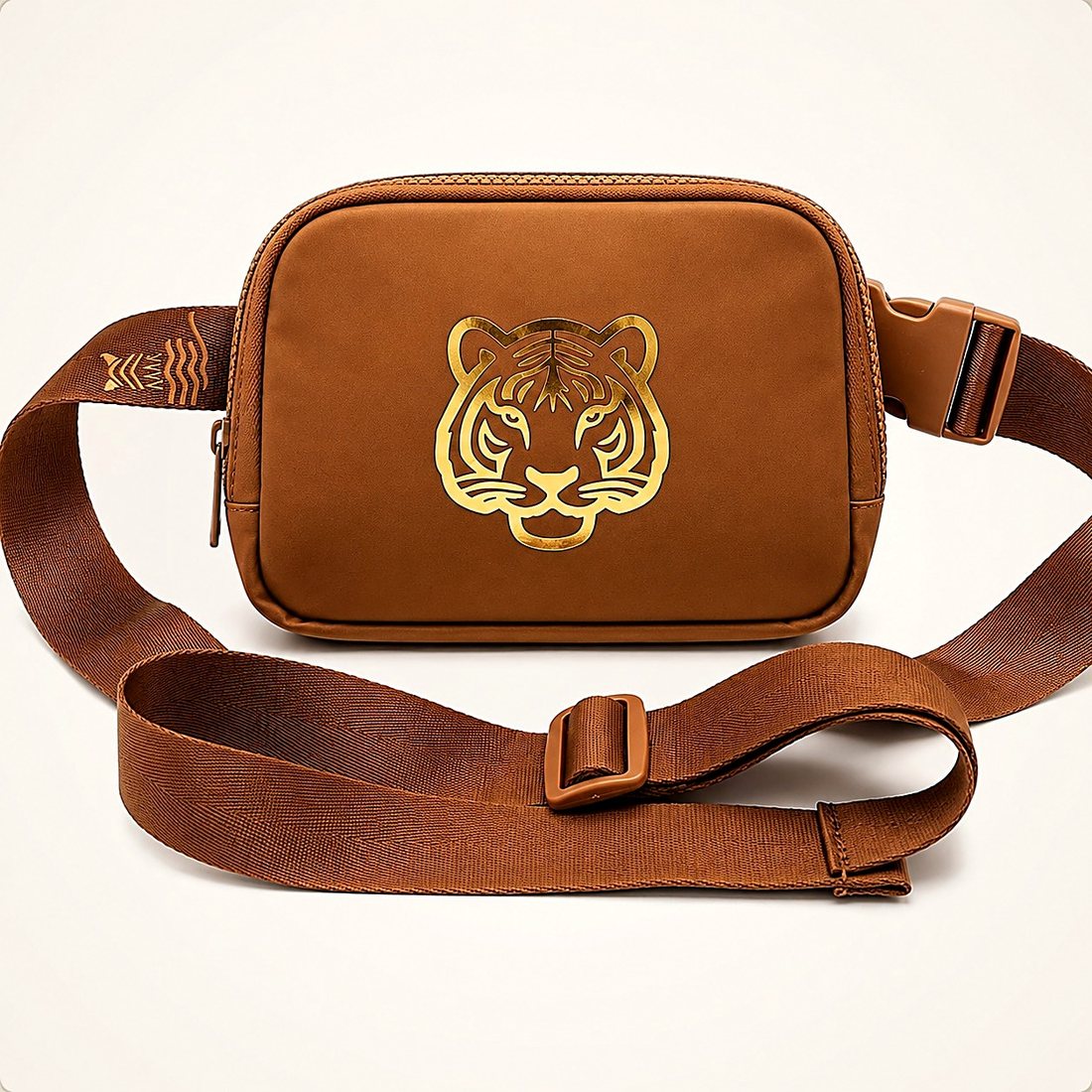 The Belt Bag in Caramel — tan leather-look belt bag with a gold foil tiger print