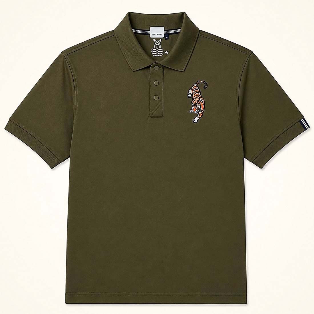 The Trail Polo in Olive — olive piqué polo with an embroidered crawling tiger at the chest